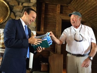 UConn Prof. Charles Yarish gives book about Long Island Sound to Sen. Murphy.