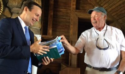 Sen. Christopher Murphy, left, receives a book about Long Island Sound from UConn marine sciences Prof. Charles Yarish at an event in Greenwich in August 2017.