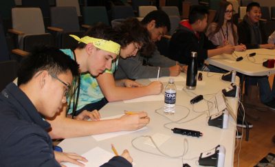 Members of one of the two teams from the Science and Technology Magnet High School of Southeastern Connecticut tackle short-answer questions during the Quahog Bowl competition.