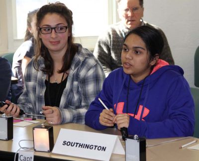 Members of the Southington High team await the next question in competition.
