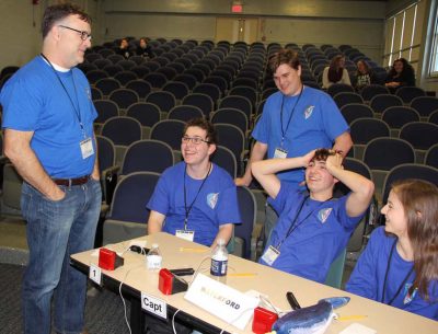 Waterford High team Coach Michael O'Connor confers with students during a break in the competition.