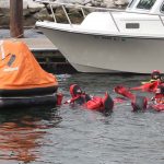 Trainees reach the life raft.