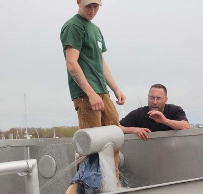 Trainer Steve Pigeon and fisherman Chad Davenport test how well the emergency repair worked to stop a leak.