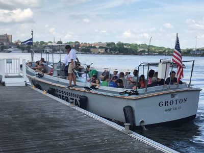 A boatload of Quest participants leaves the dock near Fort Griswold.