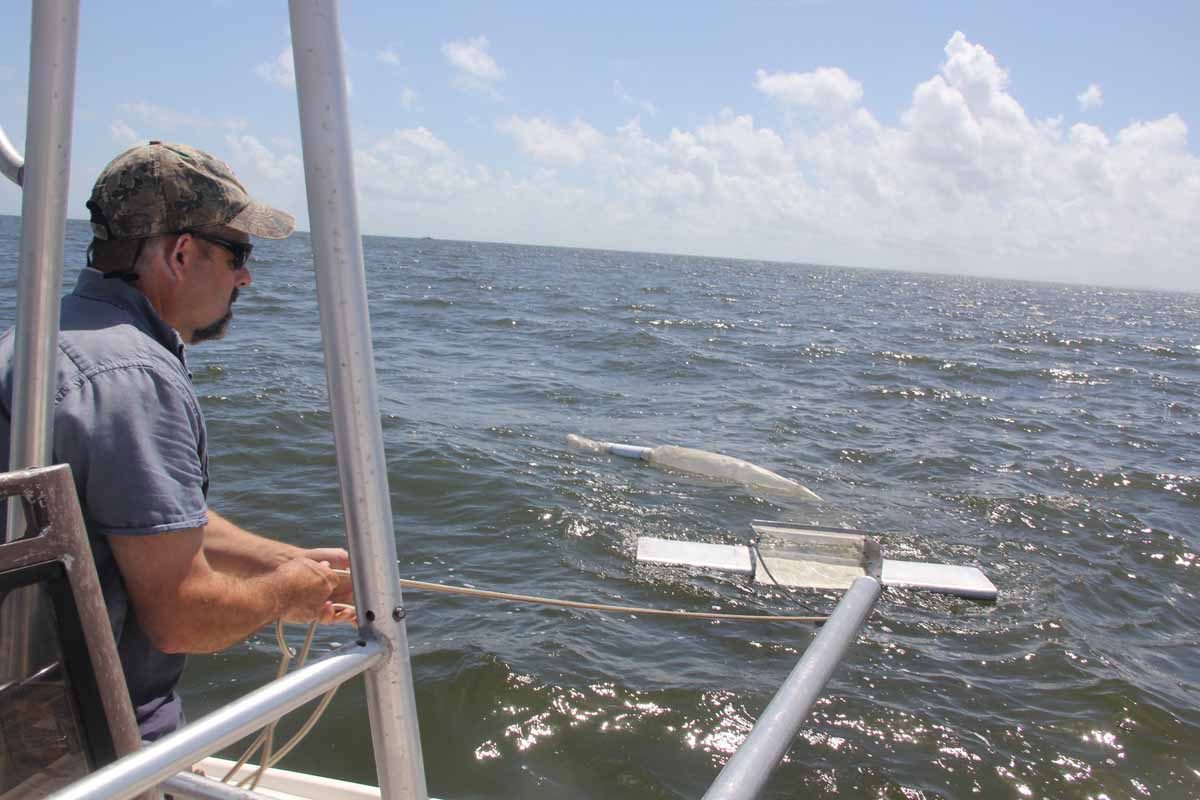 Bill Lucey, Long Island Soundkeeper for Save the Sound, releases a manta trawl net into Fairfield harbor on July 24 as part of a pilot project to characterize the extent of tiny bits of plastic called microplastics in Long Island Sound.