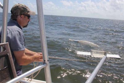 Long Island Soundkeeper Bill Lucey deploys a manta trawl net in Fairfield harbor this summer as part of a pilot project looking for microplastics in Long Island Sound.