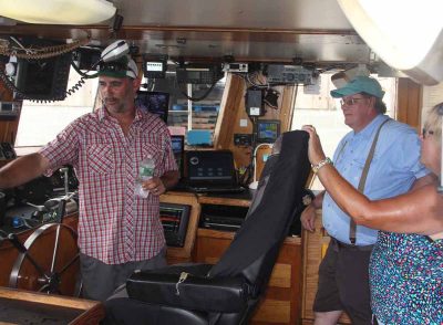 Aaron Williams, captain of Tradition, talks to visitors about his vessel during the open house. His vessel fishes for squid, scup and fluke.