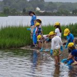 Mystic Aquarium summer campers search for trash along the shoreline at Bluff Point State Park.