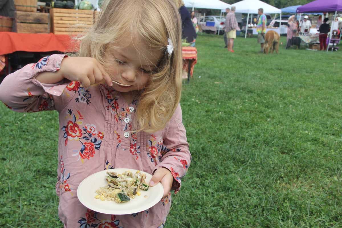 Josephine Thibodeaux, age 3, was one of the many market-goers who sampled the scup and quinoa salad.