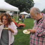 Alisa Mierejewski and Chip Dahlke enjoyed the free samples of pesto-encrusted scup with warm summer salad.