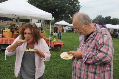 Alisa Mierejewski and Chip Dahlke enjoyed the free samples of pesto-encrusted scup with warm summer salad.