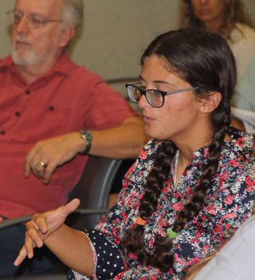 Emily Kollmer, a recent graduate of the marine vertebrate biology program at Stony Brook University, asks a question during the forum.