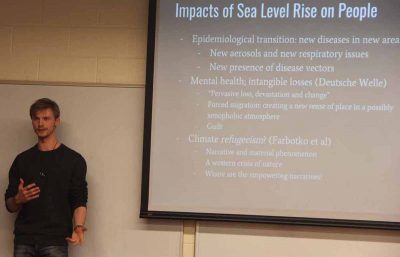 Nelson Durkee, a student in the Climate Corps course, describes the various effects of sea level rise on Miami Beach for his class presentation.