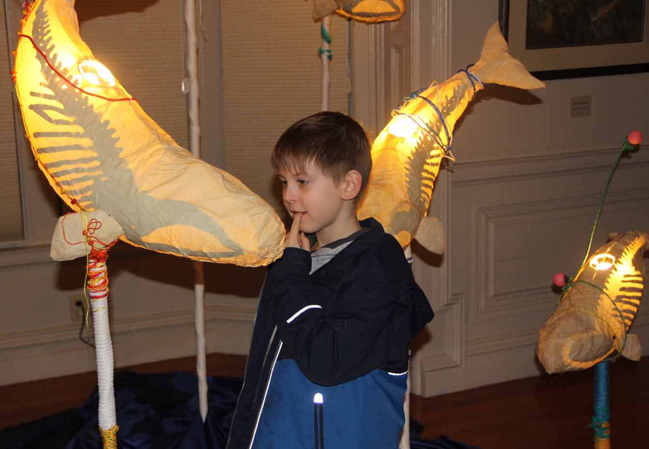 Chancellor Talbot, 8, of East Lyme, looks at one of the "Ghost Whales" created by Kristian Brevik that is part of the "Crosscurrents" exhibit of CT Sea Grant Arts Support Awards program during the opening on Jan. 24.