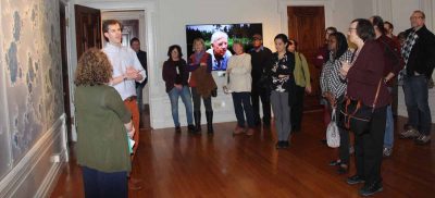 Christopher Platts, creator of the Alexey von Schlippe Gallery, talks to some of the 50 people who attended the opening of the "Crosscurrents" exhibit. Next to him is Syma Ebbin of CT Sea Grant, co-curator of the exhibit, and behind them is "Starboard," a work by Carla Goldberg.