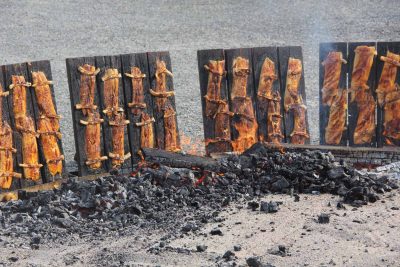 Fillets of shad caught on the Connecticut River by commercial fishermen during the spring is cooked on wooden planks over a wood fire.