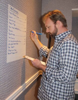 Joshua Reitsma, fisheries and aquaculture specialist at Woods Hole Sea Grant, lists challenges contributed by members of the regulations work group.