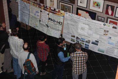 Participants discuss poster displays about seaweed research during the Seaweed Showcase.