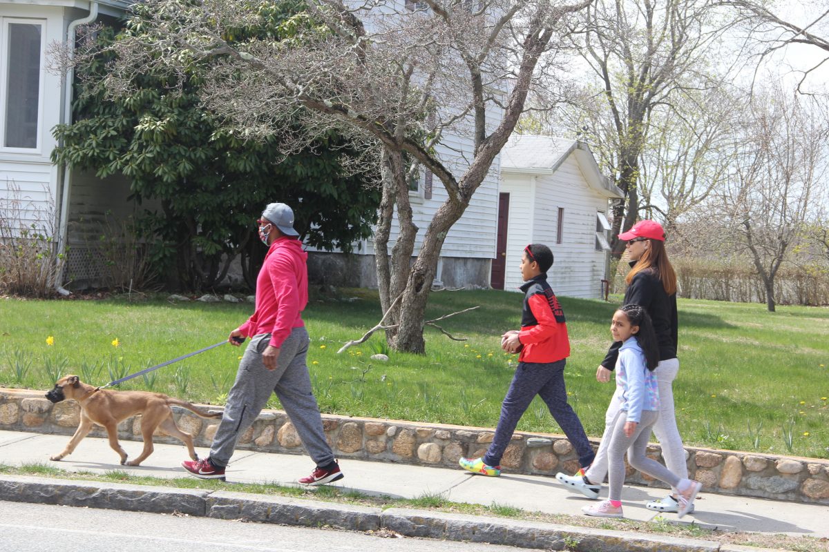 The Simonds-Dickinson family takes a noontime walk on Ocean Avenue in New London on a warm day in April.
