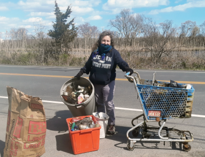 Syma Ebbin shows the haul of trash she, her husband and son collected along Thomas Road in Groton on Earth Day in 2020.
