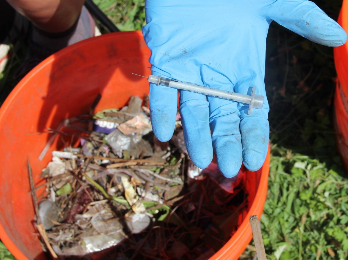 Paltauf holds one of the 10 syringes found during the cleanup.