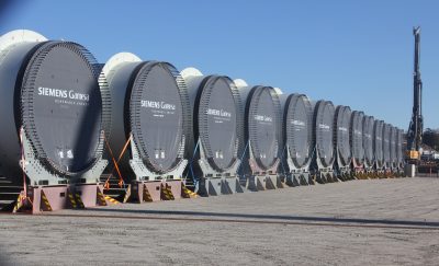 Dozens of turbine tower sections await transport to the South Fork construction site, 35 miles from State Pier.