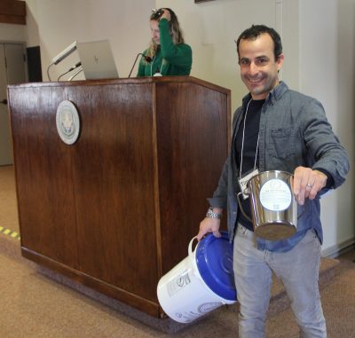 Tim Macklin, founder of the nonprofit organization Collective Oyster Recycling and Restoration (CORR), shows buckets his group can provide to other groups wanting to start shell recovery programs in their towns.