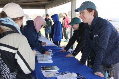 Owen Placido, far right, and Sarah Schechter, 2nd from right, share CT Sea Grant educational materials with visitors during the event.