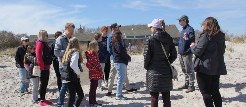 CTSG extension educators Owen Placido, second from right, and Sarah Schechter, not shown, led a talk about the formation of Connecticut's beaches to a group at the solar eclipse viewing event at Camp Harkness in Waterford on April 8.