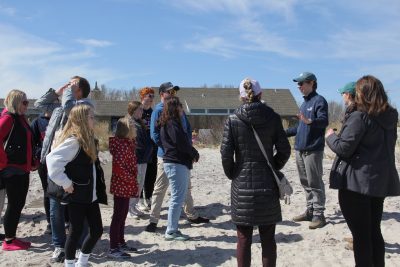 Owen Placido, third from right, explains the ecology and geology of CT beaches during a beach walk.