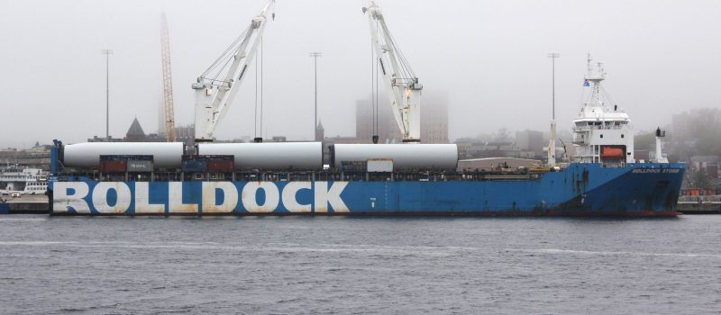 Towers for the Revolution Wind project await transport from State Pier in New London on a foggy morning in May.