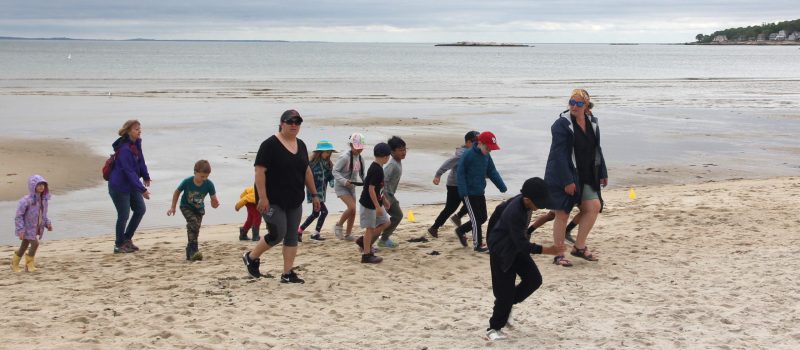 Flanders Elementary School teacher Laura Moore leads her first-grade students to a beach treasure hunt activity at Rocky Neck State Park in East Lyme on May 30, 2024, as part of the Long Island Sound Schools network program.