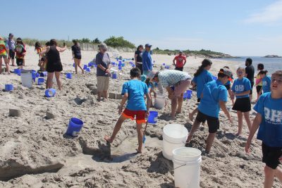Students create sand castles at one of the 16 stations at Marine Science Day at Waterford Town Beach.