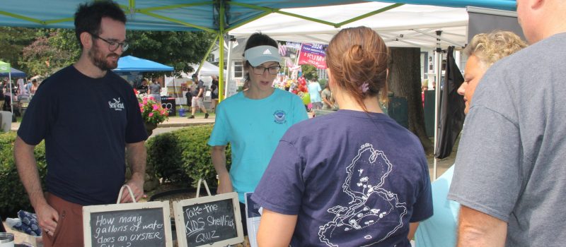 Zach Gordon, left, regional aquaculture extension liaison, and Kristen Jabanoski, science communications specialist at the NOAA Milford lab, talk to visitors about shellfish at the CTSG-Milford lab booth at the Milford Oyster Festival on Aug. 17.