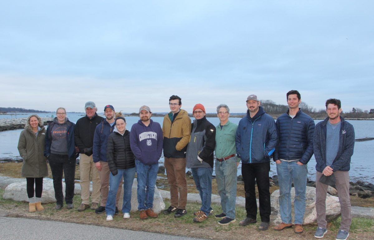 Students in the 2024 Foundations of Shellfish Farming Course, flanked by instructors Tess Getchis, far left, and Mike Gilman, far right.