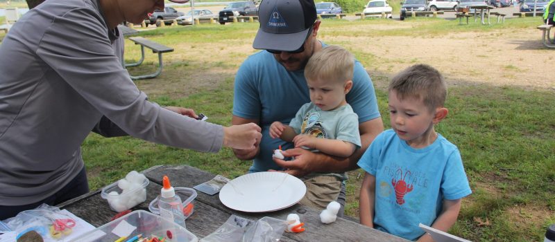 Devon Guerette of East Lyme, center, helps his sons Oliver, 2, and Bently, 4, make cotton ball piping plover chicks during the Family Fun day at Bluff Point State Park in Groton on June 8. More than 70 people attended the event, hosted by the CT NERR, CT Sea Grant and the Town of Groton.