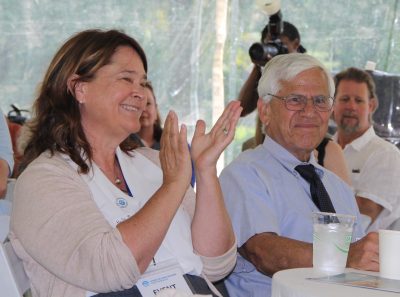 Holly Drinkuth of the CT Nature Conservancy, one of the co-chairs of the CCMP Citizens Advisory Committee, applauds as Nancy Seligson, also co-chair and event mistress of ceremonies, introduces a speaker. Seated next to her is Howard "Mickey" Weiss, founder of Project Oceanology.