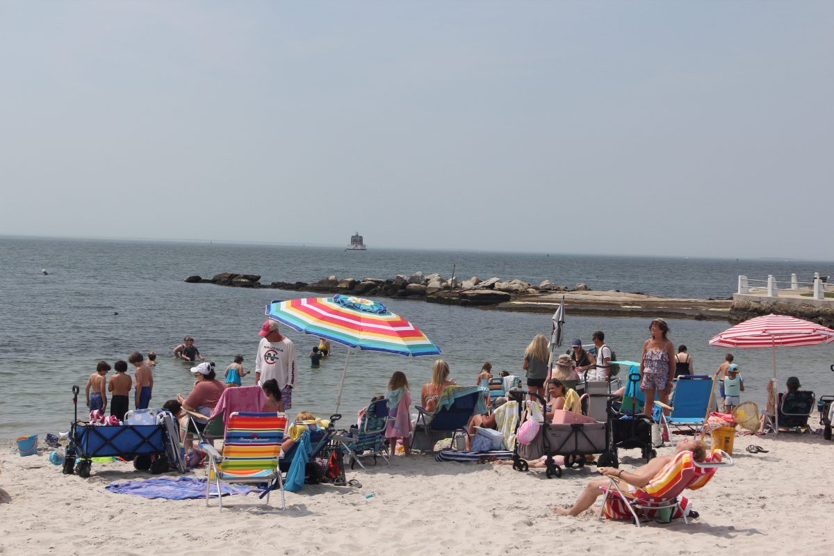 Beachgoers enjoy Eastern Point Beach in Groton on Long Island Sound on a summer day.