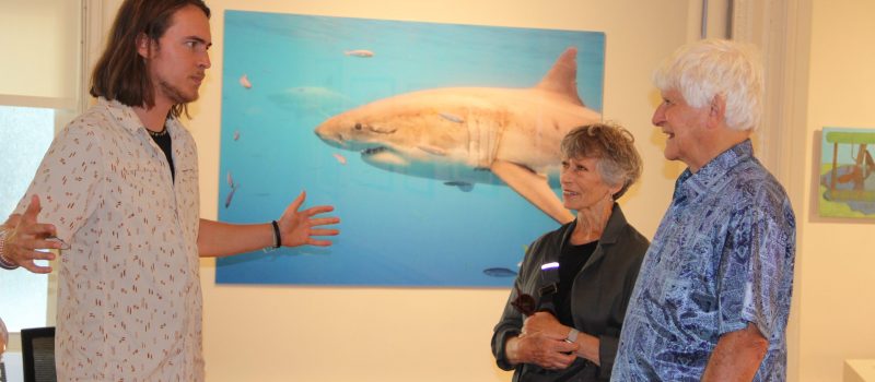 CTSG-supported photographer and videographer Tomas Koeck, left, talks to visitors at the Alexey von Schlippe Art Gallery during the opening of his exhibit of nature photos. His film "Flyway of Life" will be shown at UConn Avery Point on Oct. 1.