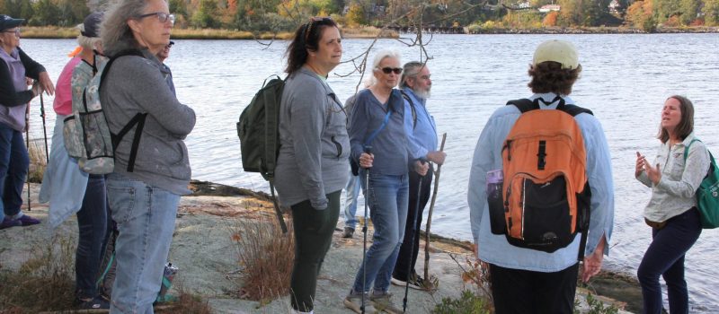 Connecticut College Arboretum Director Maggie Redfern, right, tells about 20 people on a CT Sea Grant-sponsored hike of Mamacoke Island Oct. 19 about how Indigenous people once used the area for fishing and other activities The hike was part of the Thames River Park's "Walk in the Park" series.