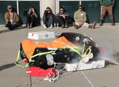 Students watch as a life raft is inflated.