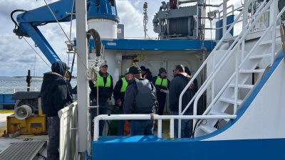 Students in drill conductor training practice an exercise aboard a UConn research vessel.