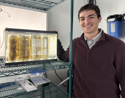 Clayton McGoldrick, lab technician at CT Sea Grant, shows some of the young kelp growing on spools in the mobile lab in the winter of 2025.