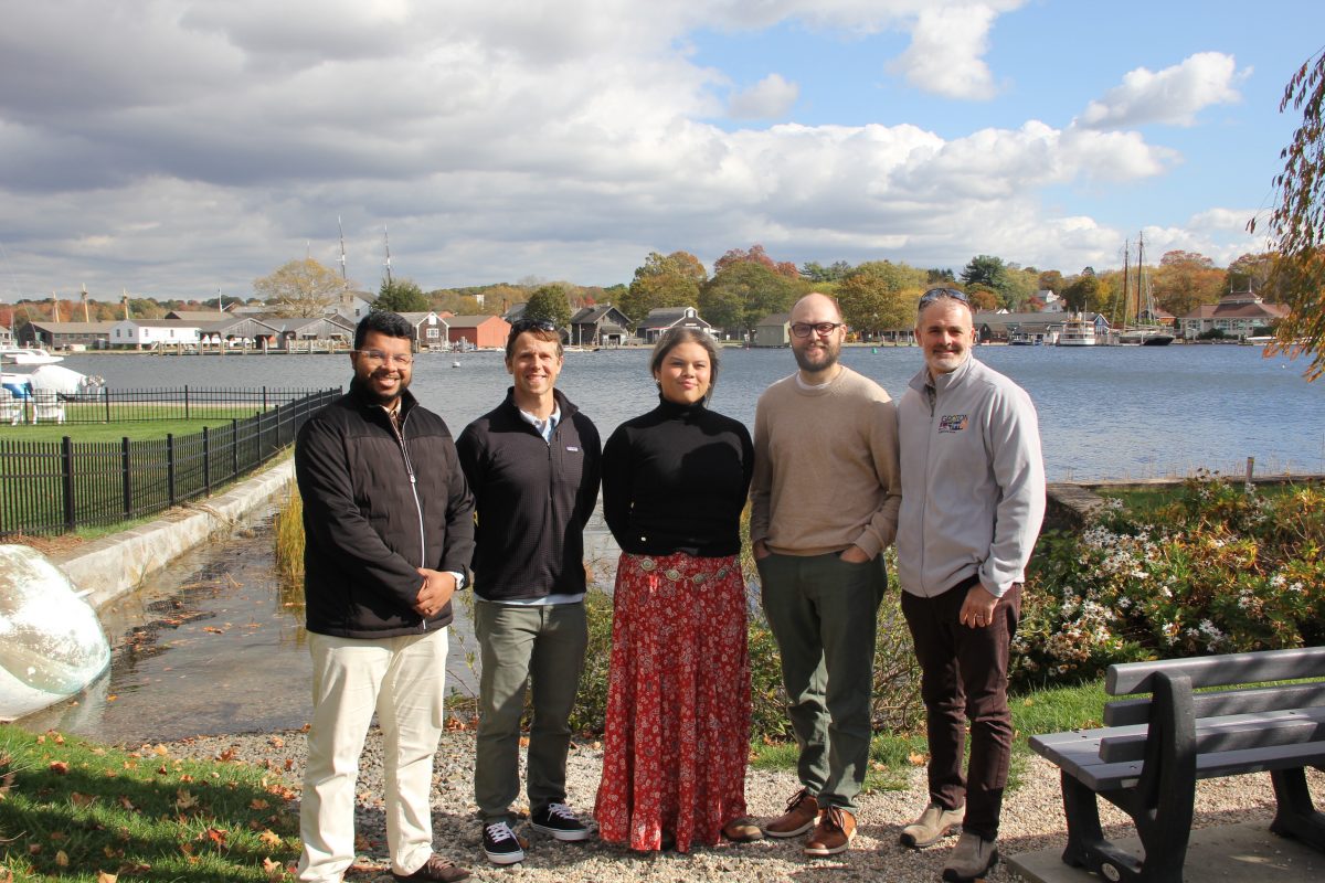 Municipal officials leading the resilience project in the Mystic section of Groton are, left to right, Sabit Nasir, sustainability and resilience manager; Johathan Reiner, director of planning and development services; Alexis Torres, sustainability and resilience specialist; Geoff Foster, town engineer; and Dave Prescott, planner II/floodplain manager. They are standing at a public access area in a neighborhood that borders the Mystic and is susceptible to flooding. Photo: Judy Benson / Connecticut Sea Grant