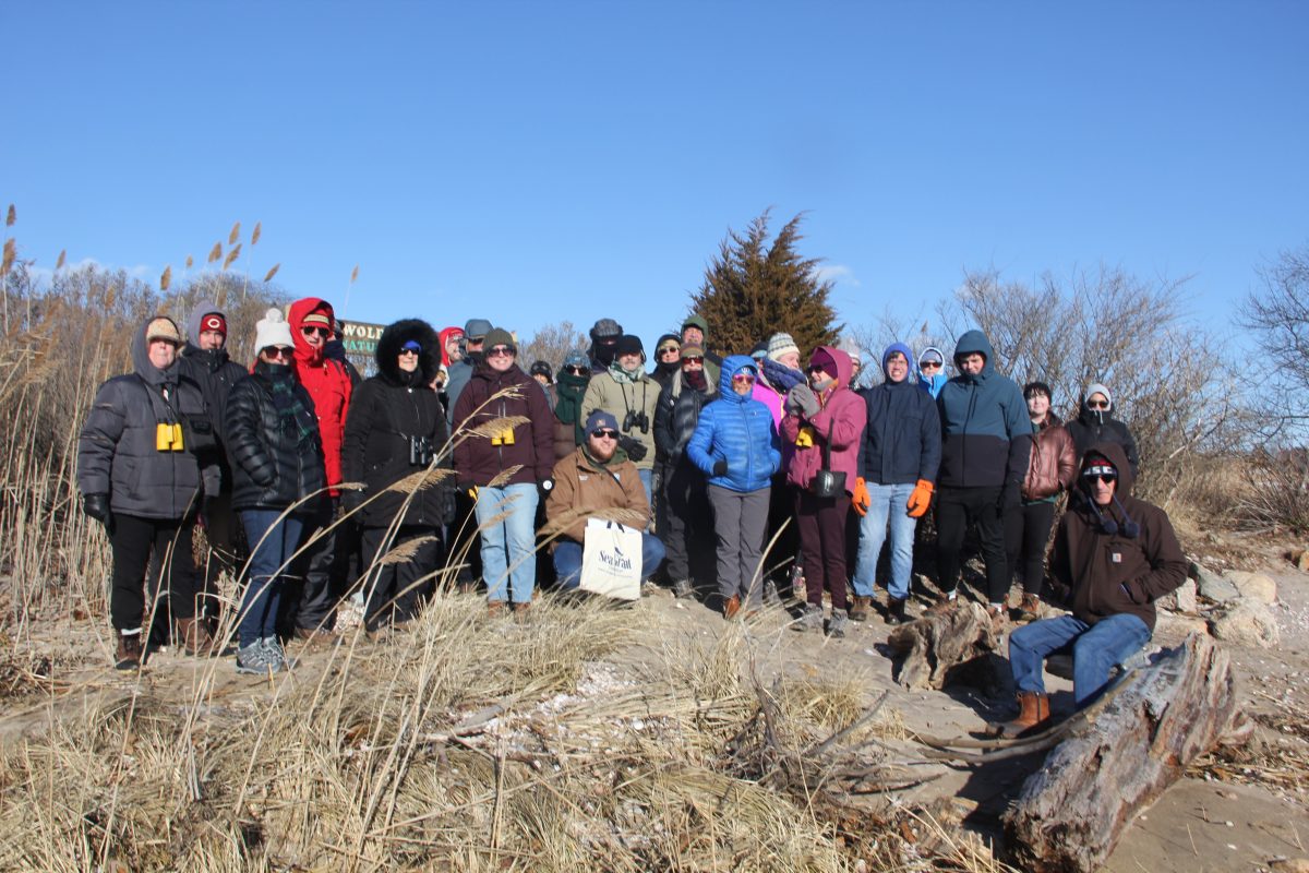 Hikers gather around the sign at the Griswold Point preserve.