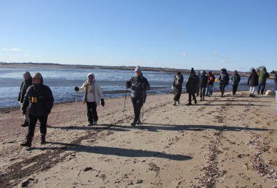 Hikers gather around the sign at the Griswold Point preserve.