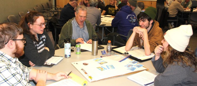 Some of the 35 students in the 2026 Foundations of Shellfish Farming class work on a group exercise to select a hypothetical site for an aquaculture farm, along with deciding on gear, location and other factors.