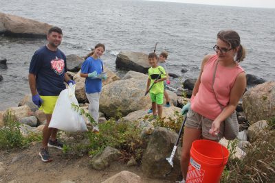 The Moriello family of Bethany extracted trash from the rocky shoreline on the southeast end of Hammonasset.